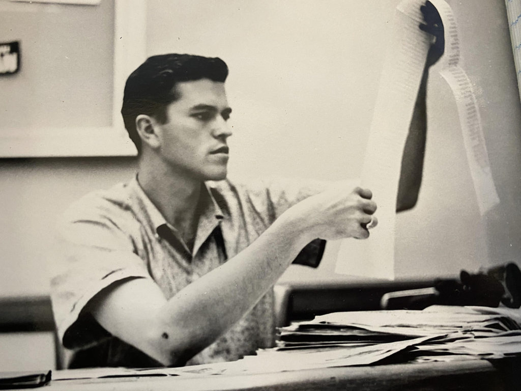 Old black-and-white photo of Hayden Freeman at a desk